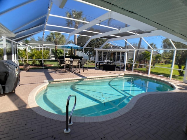 view of swimming pool with a patio area, grilling area, and glass enclosure