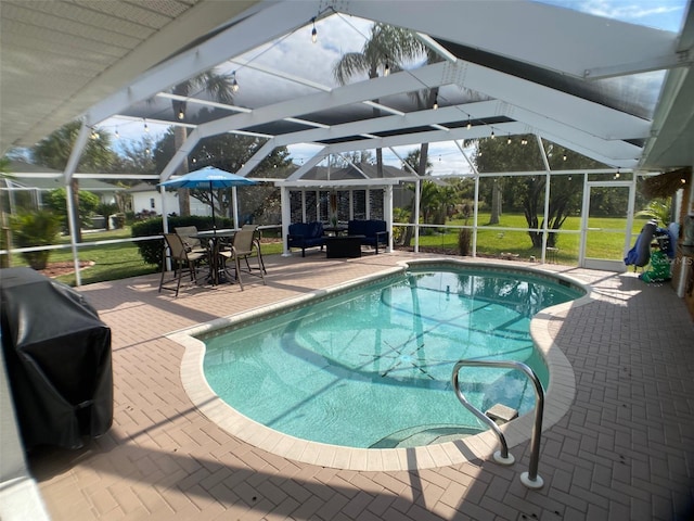 view of pool with a lanai, a patio, outdoor lounge area, and grilling area