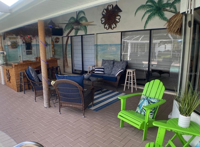 view of patio with an outdoor hangout area, a bar, and ceiling fan