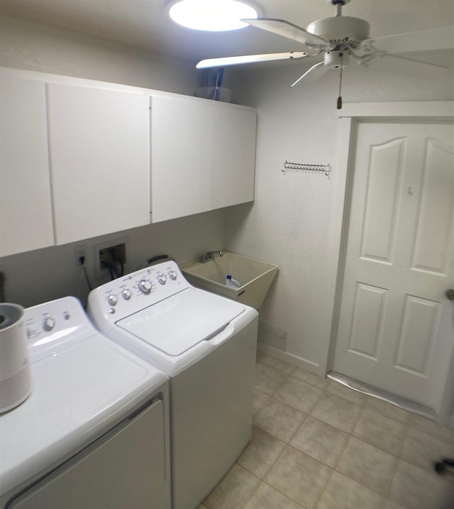 clothes washing area featuring sink, washer and clothes dryer, ceiling fan, and cabinets