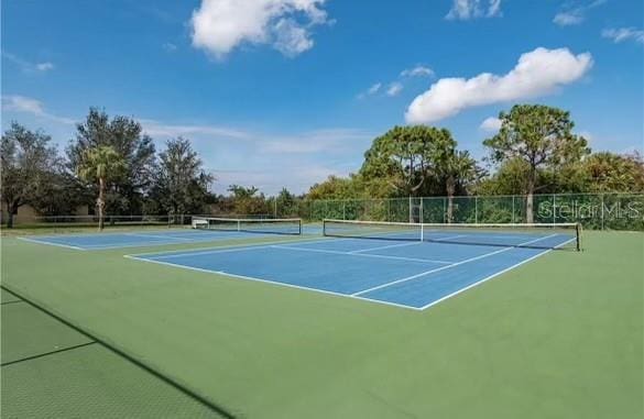 view of tennis court with basketball hoop