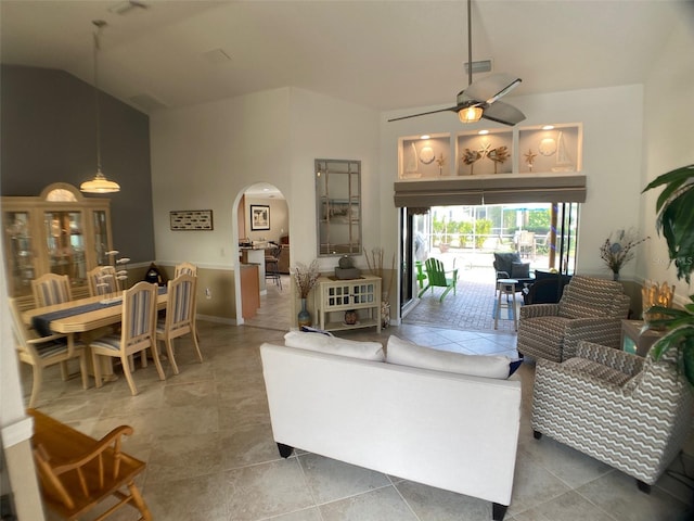 living room featuring a towering ceiling and ceiling fan