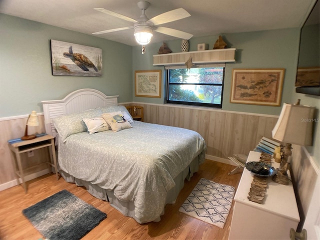 bedroom with ceiling fan and hardwood / wood-style flooring