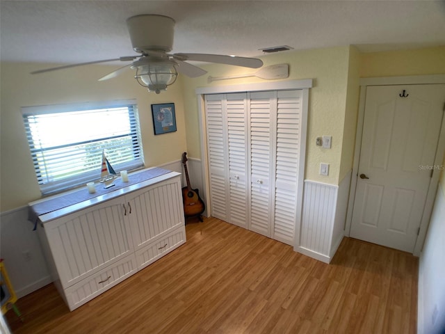 bedroom featuring ceiling fan, light hardwood / wood-style floors, and a closet