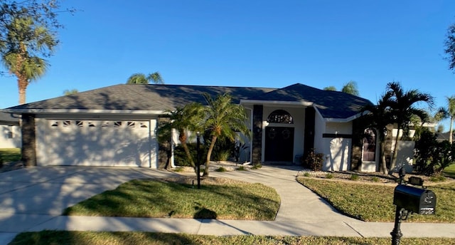 ranch-style house featuring a garage, concrete driveway, and stucco siding