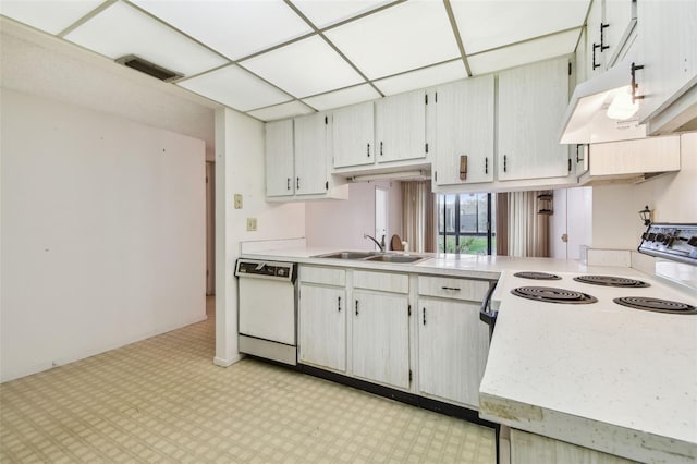 kitchen featuring a drop ceiling, white cabinetry, sink, and white appliances