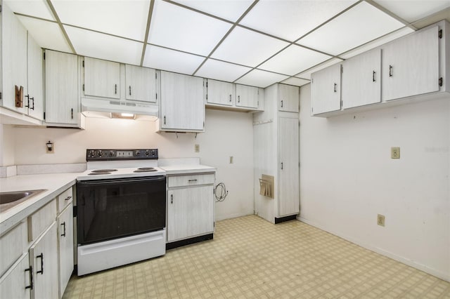 kitchen featuring white cabinetry, a paneled ceiling, and white range with electric cooktop