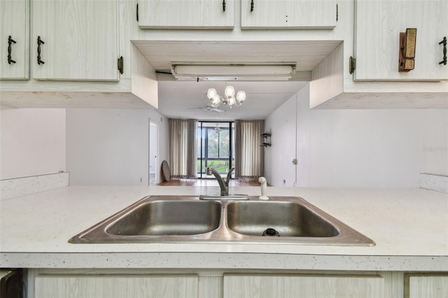 kitchen featuring pendant lighting, a notable chandelier, and sink