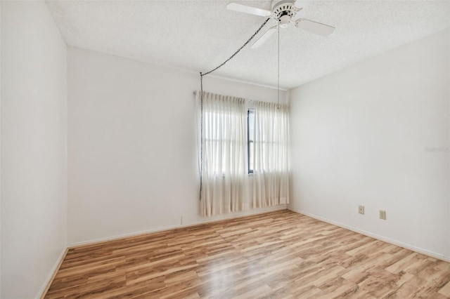 spare room with ceiling fan, wood-type flooring, and a textured ceiling