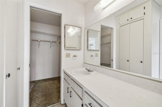 bathroom with vanity and a textured ceiling