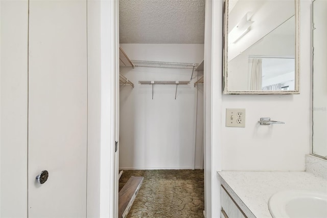 bathroom featuring vanity and a textured ceiling