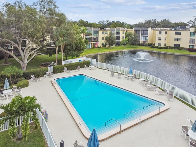 view of swimming pool with a patio area and a water view