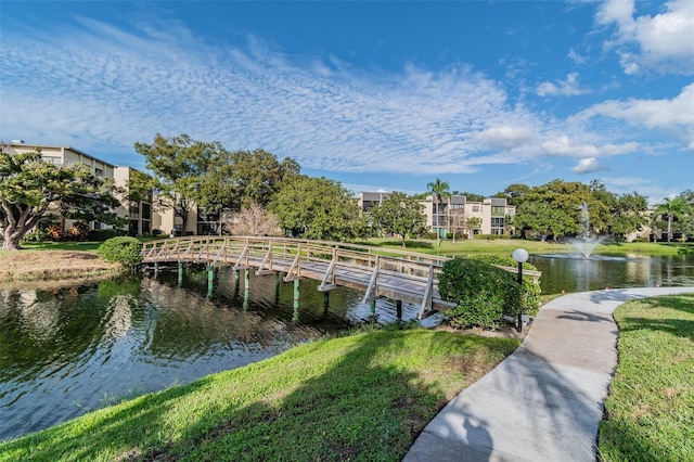 dock area featuring a yard and a water view