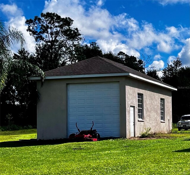 garage featuring a lawn