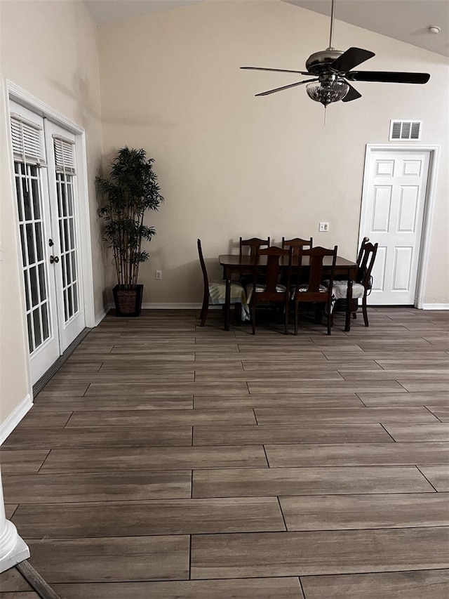 dining space featuring french doors, dark wood-type flooring, high vaulted ceiling, and ceiling fan