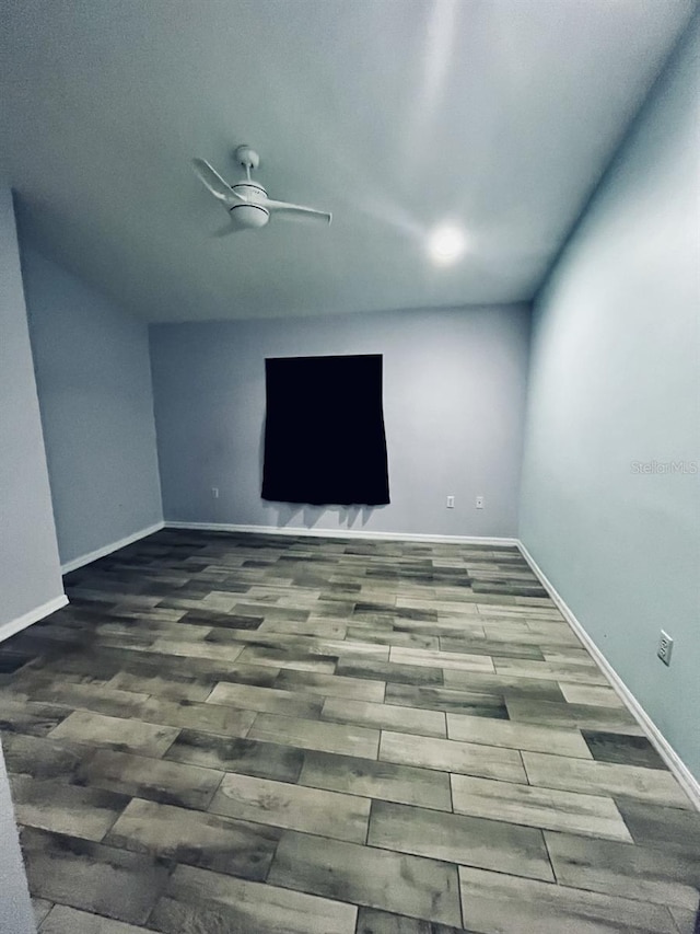 spare room with wood-type flooring and ceiling fan