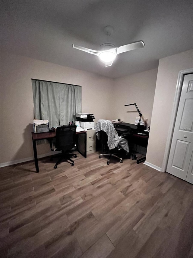 home office featuring hardwood / wood-style floors and ceiling fan