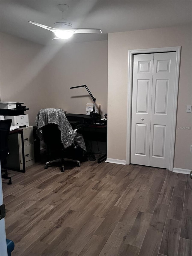 home office with ceiling fan and dark hardwood / wood-style floors