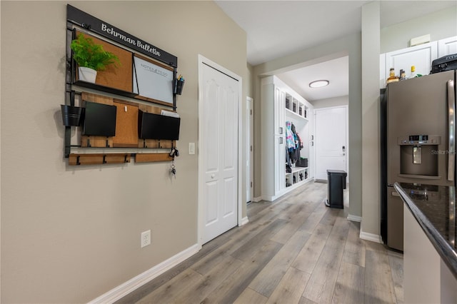 hallway with light hardwood / wood-style flooring