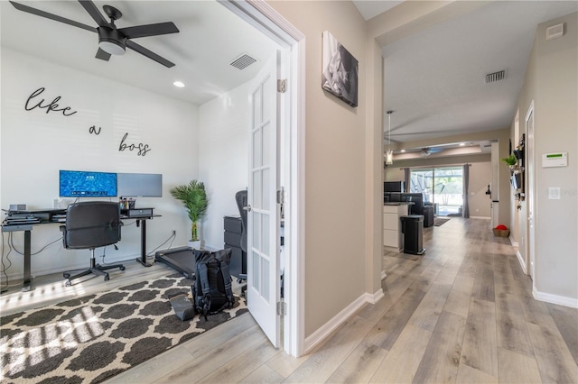 office space with ceiling fan, light hardwood / wood-style flooring, and french doors