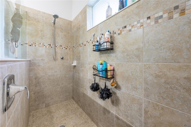 bathroom with tiled shower