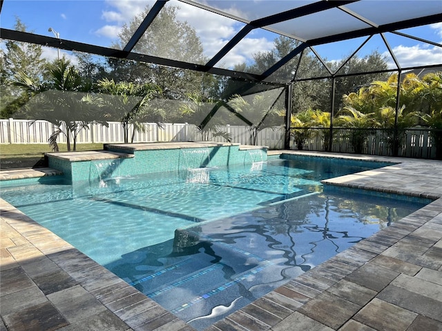 view of swimming pool featuring a jacuzzi, glass enclosure, and pool water feature