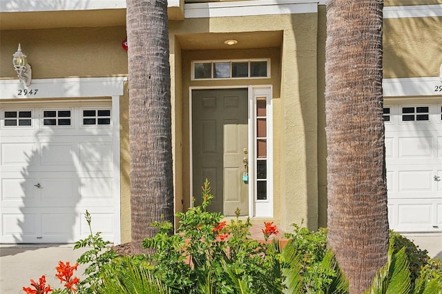 view of exterior entry with a garage