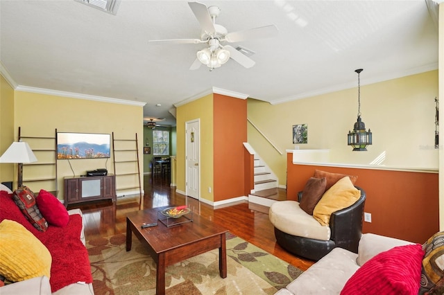 living room with ornamental molding, dark hardwood / wood-style floors, and ceiling fan