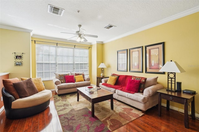 living room with hardwood / wood-style flooring, ceiling fan, ornamental molding, and a textured ceiling