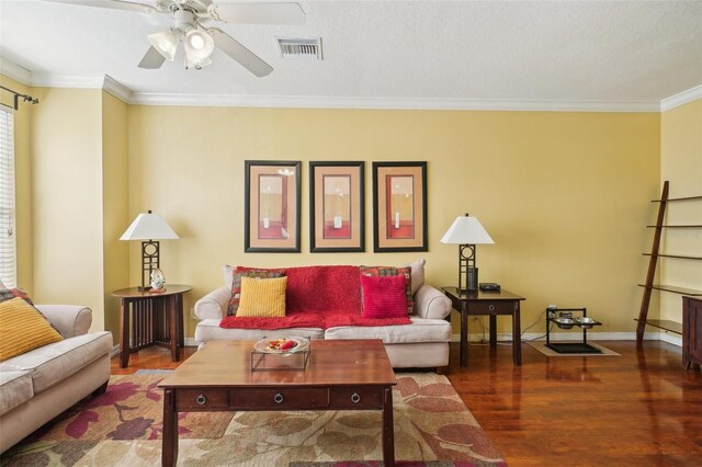 living room featuring crown molding, dark wood-type flooring, and ceiling fan