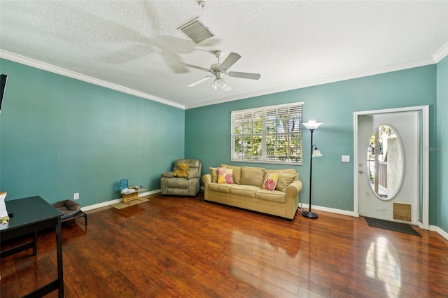 living room featuring crown molding, ceiling fan, hardwood / wood-style flooring, and a textured ceiling