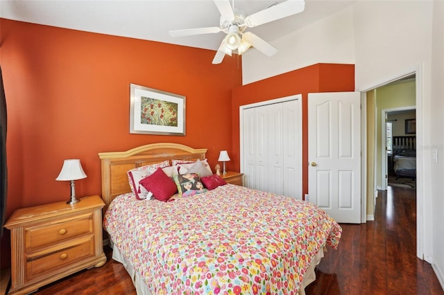 bedroom with lofted ceiling, dark hardwood / wood-style flooring, a closet, and ceiling fan