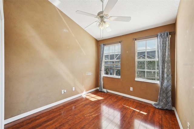 empty room with dark wood-type flooring and ceiling fan