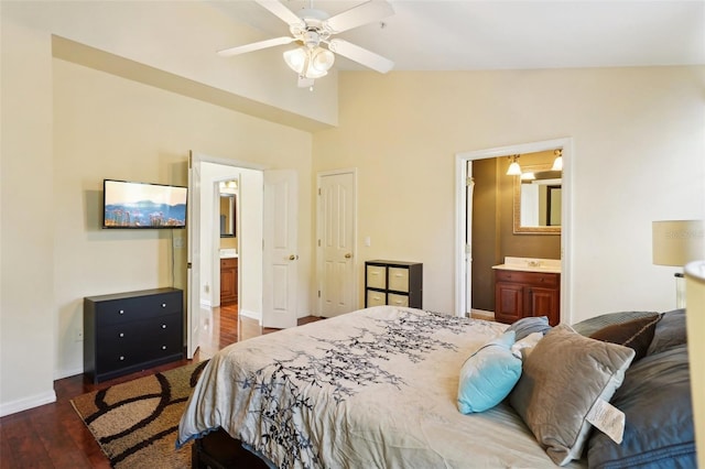 bedroom with lofted ceiling, dark hardwood / wood-style flooring, and connected bathroom