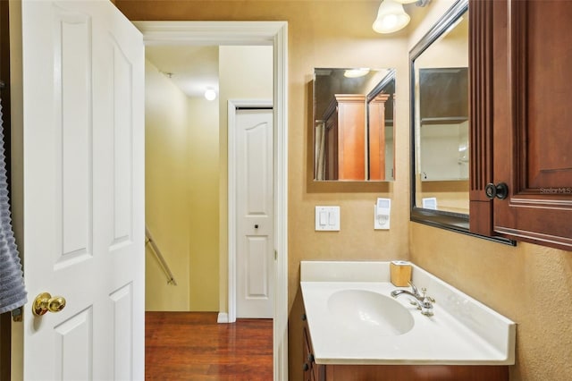 bathroom featuring hardwood / wood-style flooring and vanity