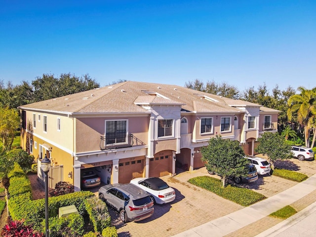 7219 Hamilton Rd Unit 7219, Bradenton, FL 34209 - view of front facade featuring stucco siding, driveway, a balcony, and a garage