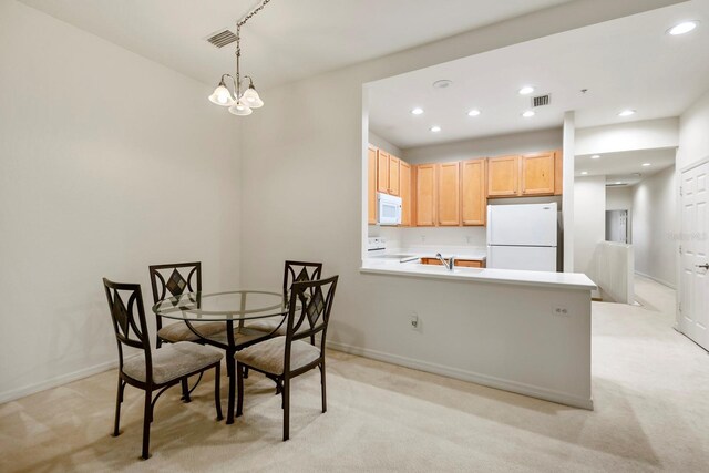 7219 Hamilton Rd Unit 7219, Bradenton, FL 34209 - dining room with an inviting chandelier, baseboards, recessed lighting, and light colored carpet