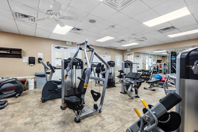 gym featuring a paneled ceiling and ceiling fan