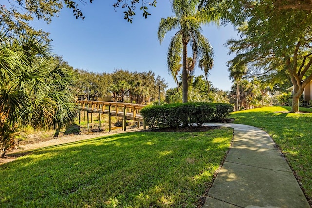 view of property's community with a lawn