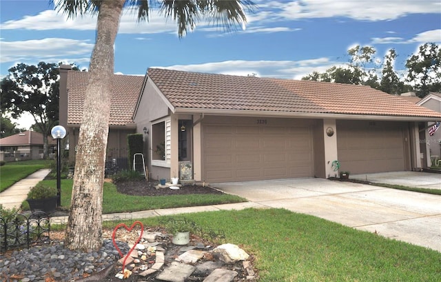 view of front facade featuring a front lawn and a garage