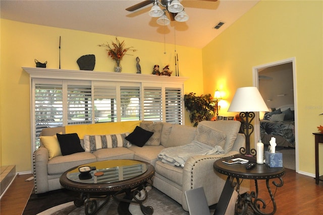 living room featuring ceiling fan, vaulted ceiling, and dark hardwood / wood-style flooring