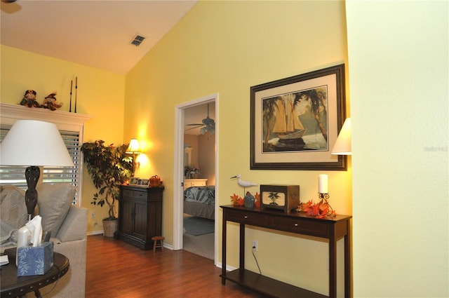 hallway with lofted ceiling and dark hardwood / wood-style floors