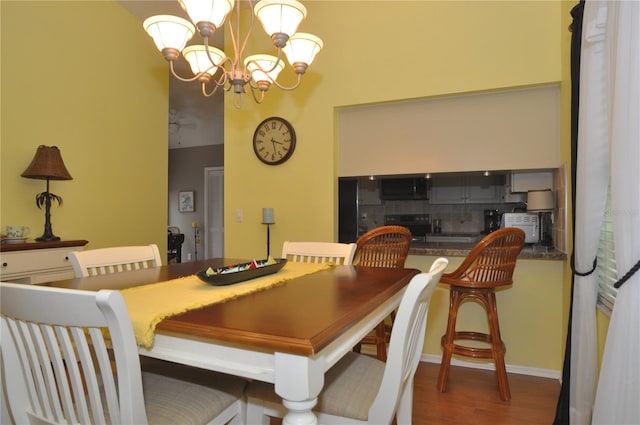 dining room with a chandelier and dark wood-type flooring