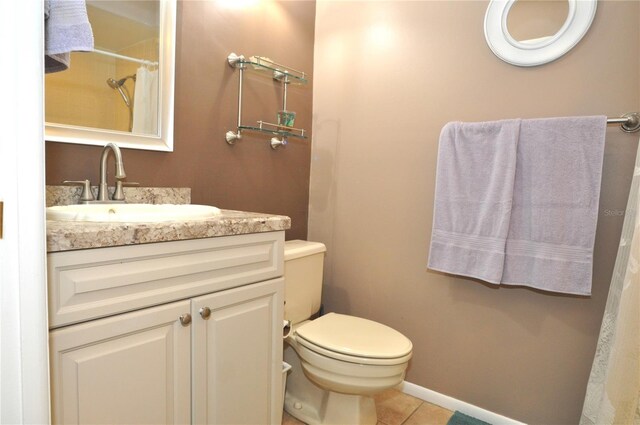 bathroom with vanity, toilet, a shower with shower curtain, and tile patterned floors