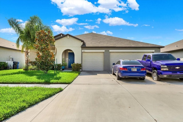 ranch-style home featuring a garage and a front lawn