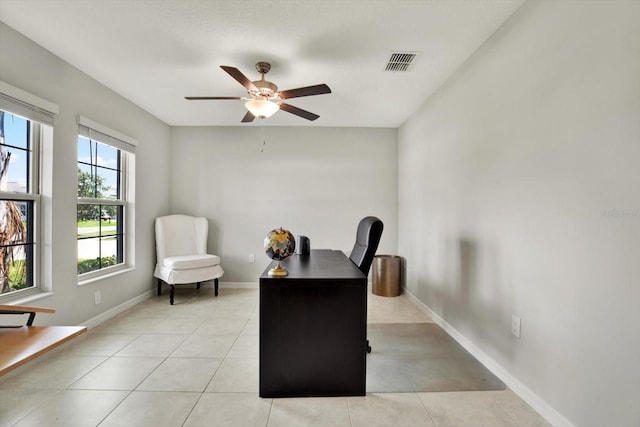 office space featuring ceiling fan and light tile patterned floors