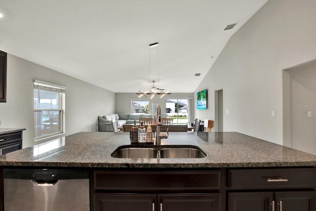 kitchen featuring lofted ceiling, stone counters, sink, and dishwasher