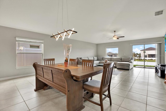 tiled dining room featuring ceiling fan