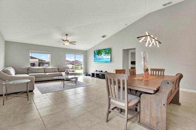 dining room with high vaulted ceiling, ceiling fan, and light tile patterned floors