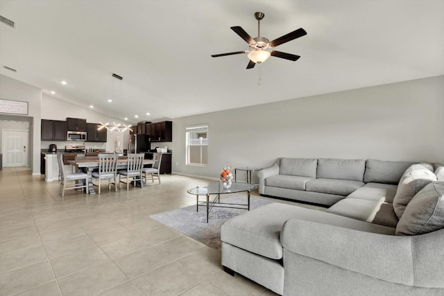 living room with lofted ceiling, light tile patterned floors, and ceiling fan